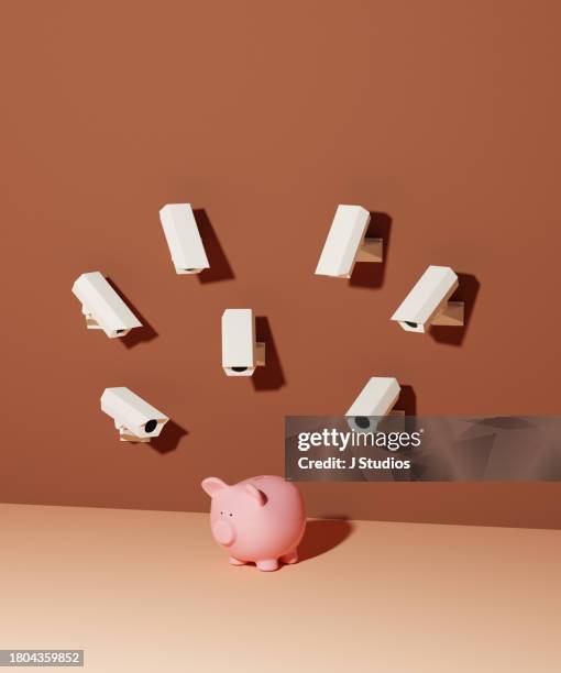 security cameras watching a piggy bank - interrogatorio foto e immagini stock