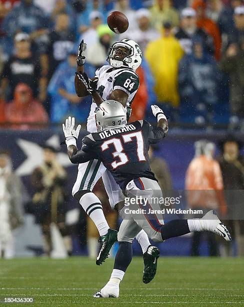 Stephen Hill of the New York Jets catches a pass over Alfonzo Dennard of the New England Patriots in the second half during the game at Gillette...