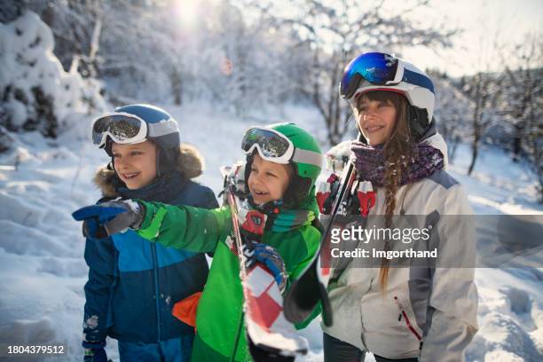 happy kids skiing in beautiful winter forest - happy skier stockfoto's en -beelden