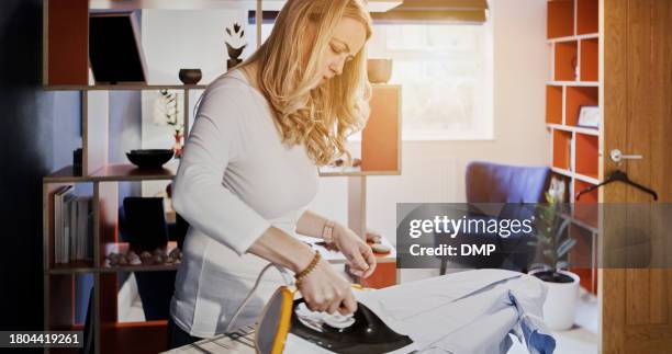 iron, clothes and woman in morning with laundry, cleaning and steam fabric on board. ironing, table or cleaner working in apartment, home or living room with housekeeping service or care for clothing - iron appliance stock pictures, royalty-free photos & images