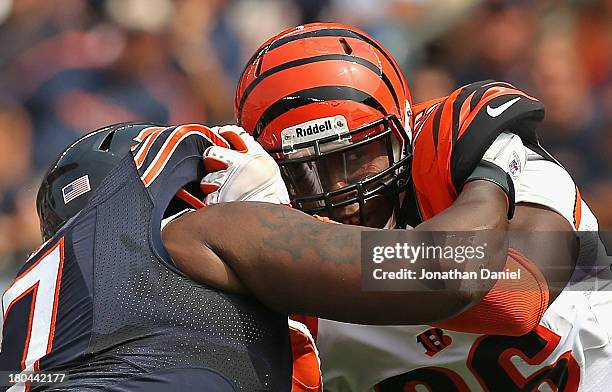 Carolos Dunlap of the Cincinnati Bengals rushes against Jodan Mills of the Chicago Bears at Soldier Field on September 8, 2013 in Chicago, Illinois....