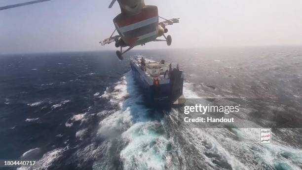 This handout screen grab captured from a video shows Yemen's Houthi fighters' takeover of the Galaxy Leader Cargo in the Red Sea coast off Hudaydah,...