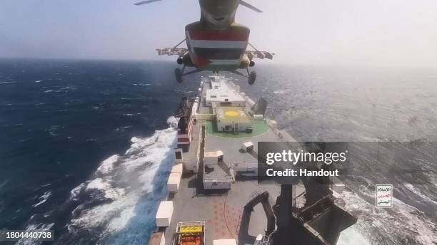 This handout screen grab captured from a video shows Yemen's Houthi fighters' takeover of the Galaxy Leader Cargo in the Red Sea coast off Hudaydah,...