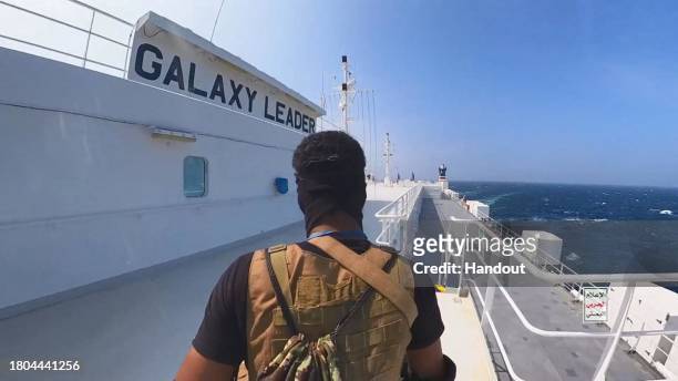 This handout screen grab captured from a video shows Yemen's Houthi fighters' takeover of the Galaxy Leader Cargo in the Red Sea coast off Hudaydah,...