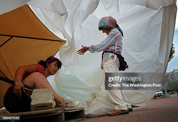 Connie Picciotto, right, and fellow activist Feriha Kaya reassemble her peace vigil tent, which was taken down last night by authorities when it was...