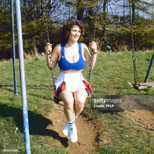 Portrait of British bookstore employee Erika Roe, also known as the Twickenham Streaker, as she sits on a swing, London, England, March 24, 1982. The...