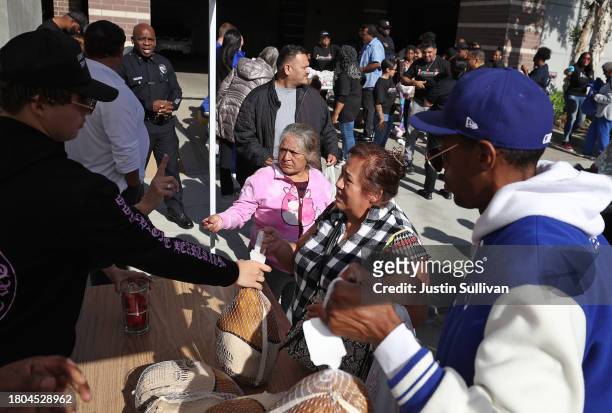 People receive free turkeys during the 3rd annual Los Angeles Police Department turkey drive at Wilshire Station on November 20, 2023 in Los Angeles,...