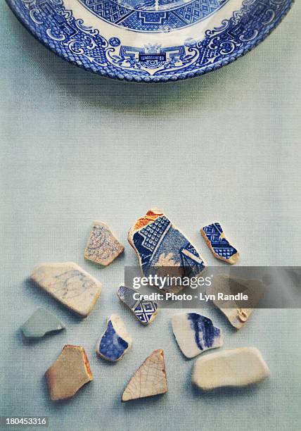 picking up the broken pieces - smashed crockery stock pictures, royalty-free photos & images