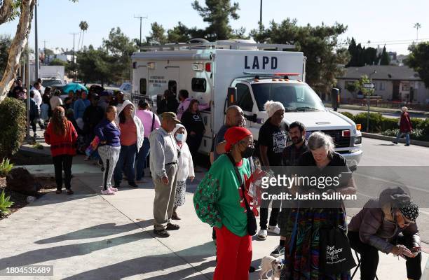 People line up to receive a free turkey and bag of food during the 3rd annual Los Angeles Police Department turkey drive at Wilshire Station on...
