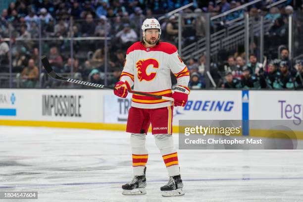 Chris Tanev of the Calgary Flames looks on during the second period of a game against the Seattle Kraken at Climate Pledge Arena on November 20, 2023...