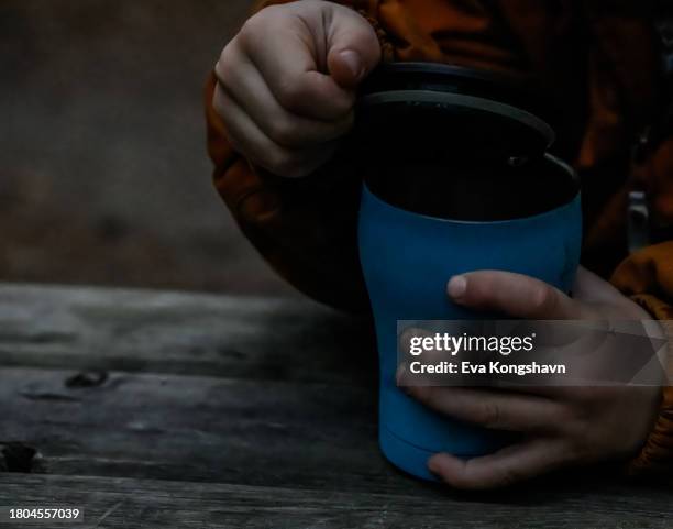 taking off the lid of the warm cup of chocolate - travel mug stock pictures, royalty-free photos & images