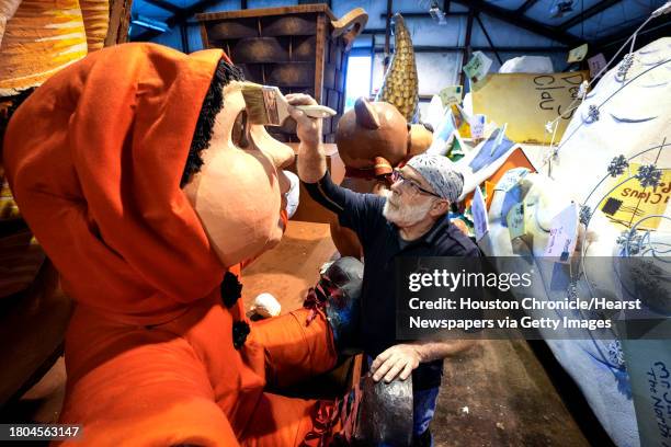 Mark Perelli, of Studio 3 Inc., New Orleans, works on putting the finishing touches on one of the floats for the 74th Annual H-E-B Thanksgiving Day...