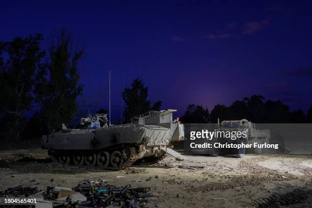 An armoured fighting vehicle stands at a fortified forward observation post overlooking the border with Gaza on November 20, 2023 in Southern Israel....