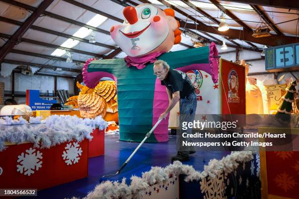 Adrian Arbes, of Studio 3 Inc., New Orleans, paints the the KHOU Secret Santa float while getting it ready for the 74th Annual H-E-B Thanksgiving Day...