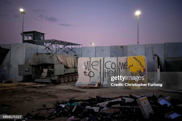 Graffiti saying 'Welcome To Hell' is adorned on the outside of a fortified forward observation post overlooking the border with Gaza on November 20,...