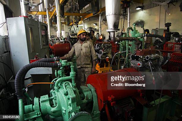 An employee tests an engine on the production line of the Millat Tractors Ltd. Assembly plant in Lahore, Pakistan, on Thursday, Aug. 29, 2013. Millat...