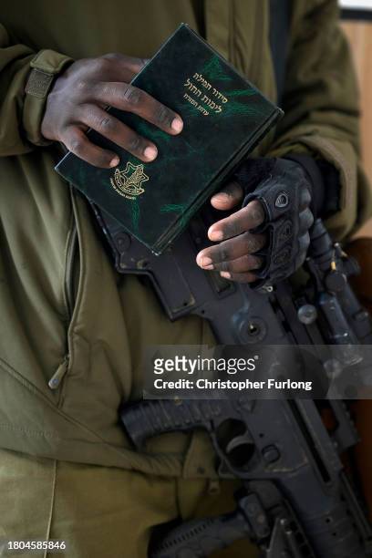 Israeli infantry soldiers pray in a synagogue near the border during training in readiness for possible deployment across the border into Gaza on...