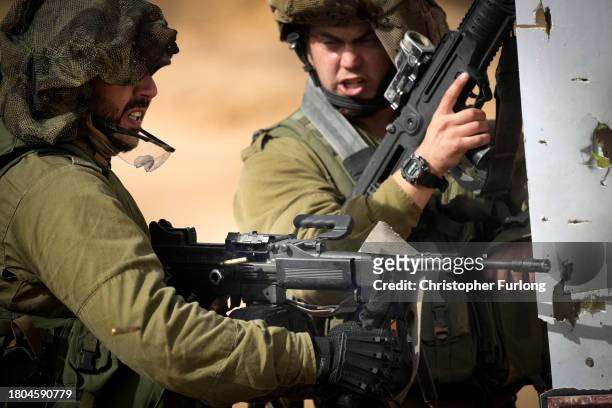 Israeli infantry soldiers take part in a live firing tactical advance exercise near the border in readiness for possible deployment across the border...