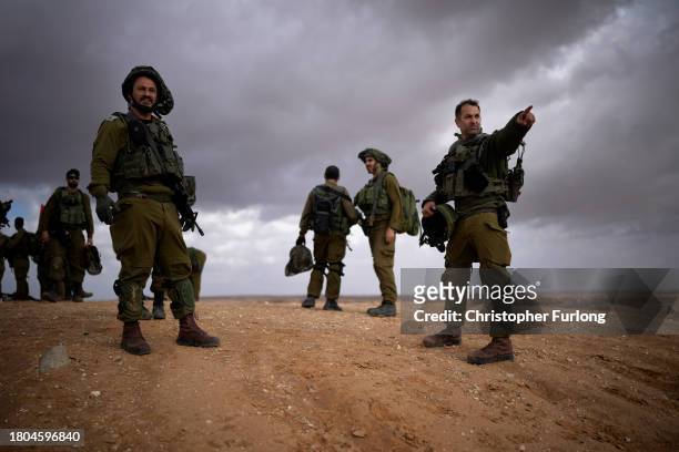 Israeli infantry soldiers take part in a live firing tactical advance exercise near the border in readiness for possible deployment across the border...