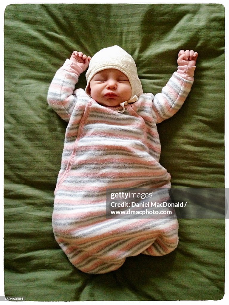 Infant baby girl bundled and napping