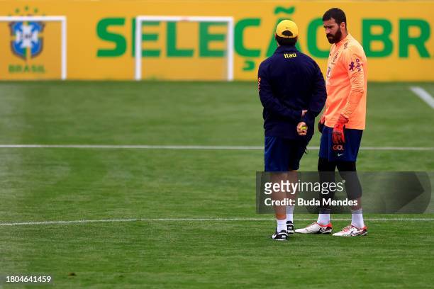 Head coach Fernando Diniz talks with a goalkeeper Alisson during a training session of the Brazilian national football team at the squad's Granja...