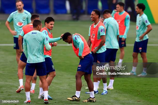 Raphael Veiga jokes with Endrick during a training session of the Brazilian national football team at the squad's Granja Comary training complex on...