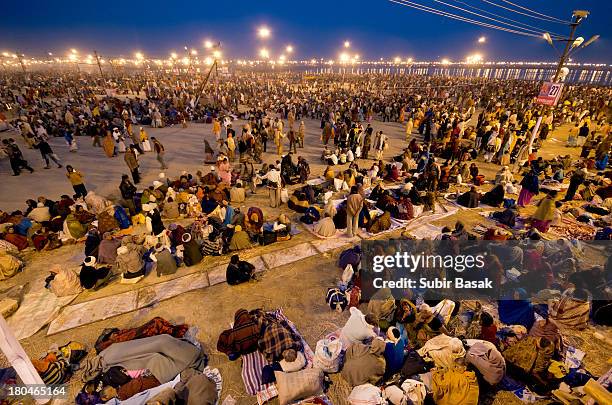 Hindu devotees gather themselves on the banks of Sangam, the confluence of the holy rivers Ganges, Yamuna and the mythical Saraswati, during the Maha...