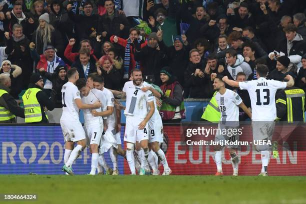 Benjamin Verbic of Slovenia celebrates with teammates after scoring the team's second goal during the UEFA EURO 2024 European qualifier match between...