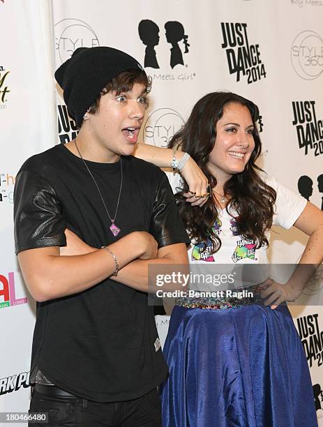 Recording artist Austin Mahone and designer Stacy Igel attend Just Dance with Boy Meets Girl at Fashion Pavilion in Chelsea on September 12, 2013 in...