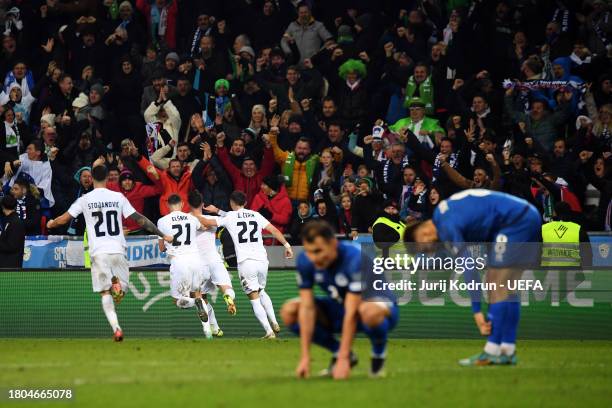 Benjamin Verbic of Slovenia celebrates with teammates after scoring the team's second goal during the UEFA EURO 2024 European qualifier match between...