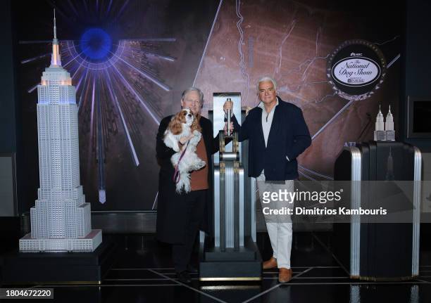 David Frei, holding "TruDat" and John O'Hurley pose as they light the Empire State Building in honor of the National Dog Show at The Empire State...