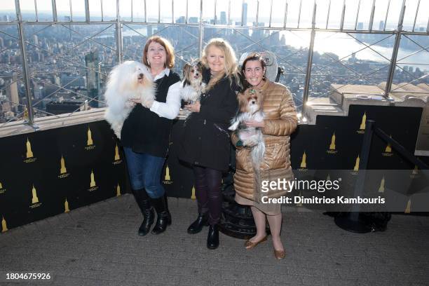 Adrianne Dering poses with her dog "Monkey", Connie Shook Evans poses with her dog "Nemo"and Whitney Aronson poses with her dog "OnY" as John...