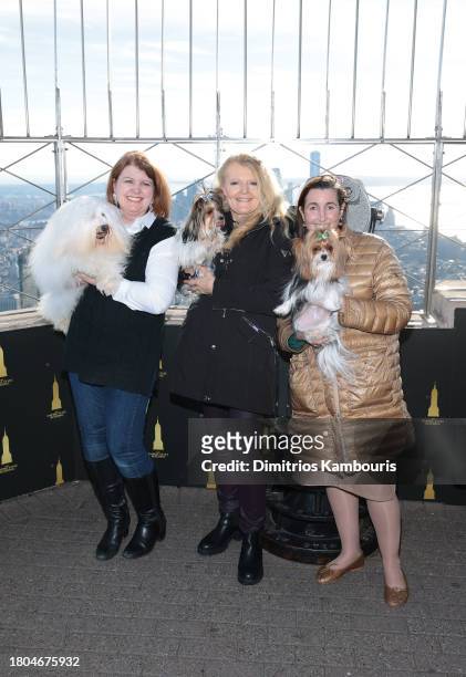 Adrianne Dering poses with her dog "Monkey", Connie Shook Evans poses with her dog "Nemo" and Whitney Aronson poses with her dog "OnY" as John...