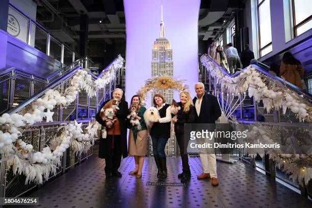 David Frei and John O'Hurley light the Empire State Building in honor of the National Dog Show as they pose with Whitney Aronson and her dog "OnY",...