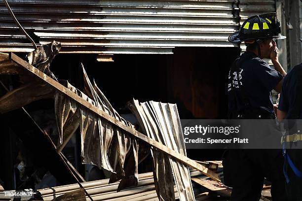 Firefighter stands at the scene of a massive fire that destroyed dozens of businesses along an iconic Jersey shore boardwalk on September 13, 2013 in...