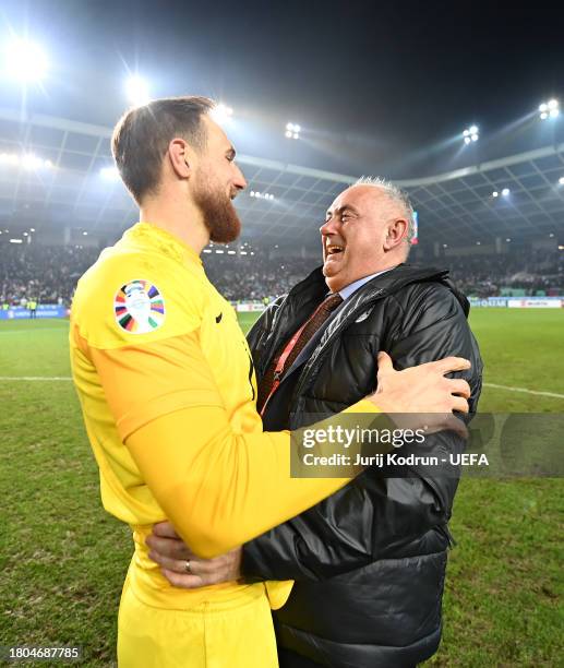 Jan Oblak of Slovenia and President of the Football Association of Slovenia, Radenko Mijatovic, celebrate after the team's victory in the UEFA EURO...