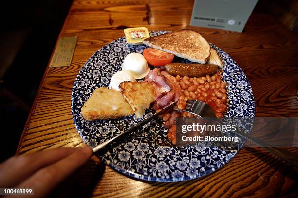Full English cooked breakfast is seen in this arranged photograph taken inside a JD Wetherspoon Plc pub in London, U.K., on Friday, Sept. 13, 2013....