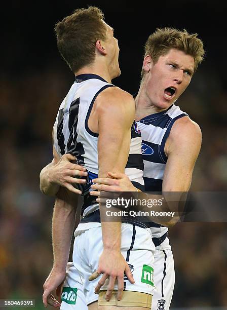 Joel Selwood of the Cats is congratulated by Mark Blicavs after kicking a goal during the Second Semi Final match between the Geelong Cats and the...