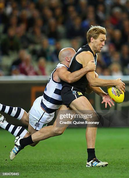 Paul Chapman of the Cats tackles Kane Cornes of the Power during the Second Semi Final match between the Geelong Cats and the Port Adelaide Power at...