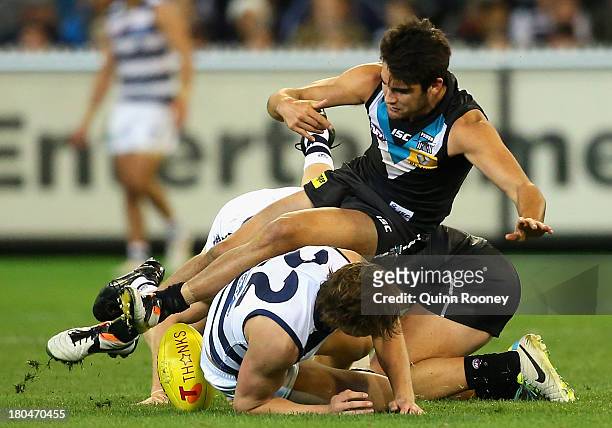 Chad Wingard of the Power has his feet taken out by Mitch Duncan of the Cats during the Second Semi Final match between the Geelong Cats and the Port...