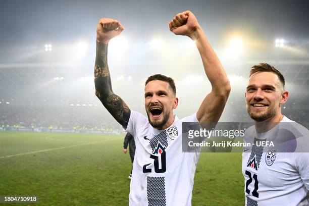 Petar Stojanovic and Timi Elsnik of Slovenia celebrate after the team's victory in the UEFA EURO 2024 European qualifier match between Slovenia and...