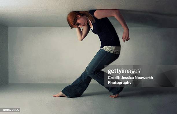 girl trapped in narrow white space - people trapped stock pictures, royalty-free photos & images