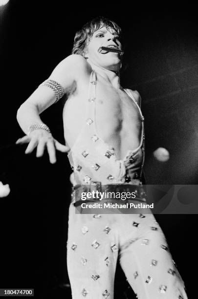 Singer Mick Jagger playing the harmonica during a performance with the Rolling Stones at Kings Hall, Manchester, 11th September 1973.