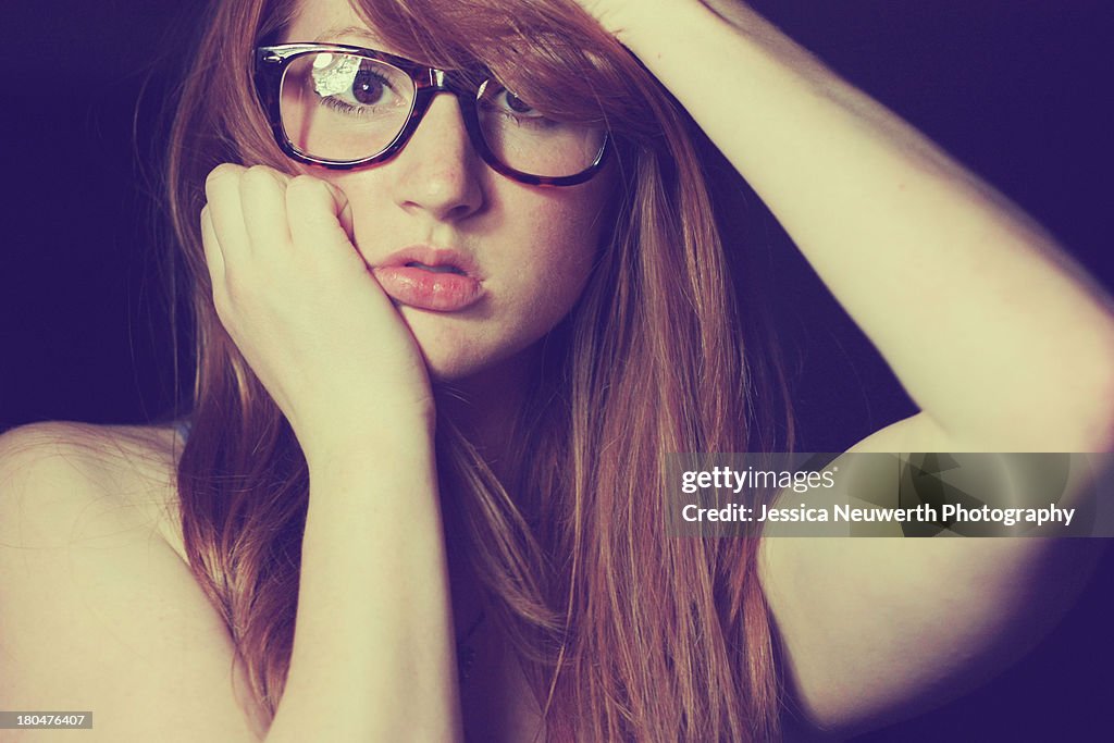 Redheaded woman with large glasses