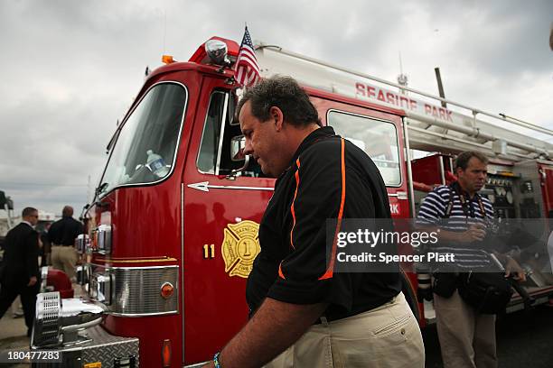 New Jersey Gov. Chris Christie walks away after speaking to the media at the scene of a massive fire that destroyed dozens of businesses along an...