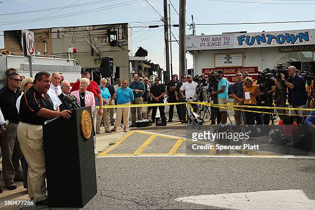 New Jersey Gov. Chris Christie speaks to the media at the scene of a massive fire that destroyed dozens of businesses along an iconic Jersey shore...