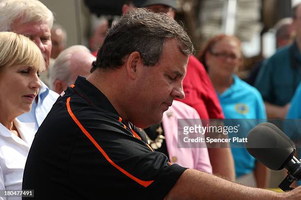 New Jersey Gov. Chris Christie speaks to the media at the scene of a massive fire that destroyed dozens of businesses along an iconic Jersey shore...