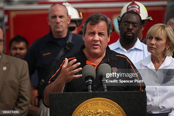 New Jersey Gov. Chris Christie speaks to the media at the scene of a massive fire that destroyed dozens of businesses along an iconic Jersey shore...