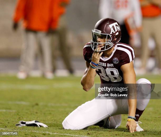 Holder Matthew Coleman of the Texas A&M Aggies awaits the snap against the Sam Houston State Bearkats at Kyle Field on September 7, 2013 in College...