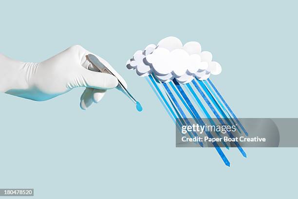 hand holding a drop of paper craft rain from cloud - white glove fotografías e imágenes de stock